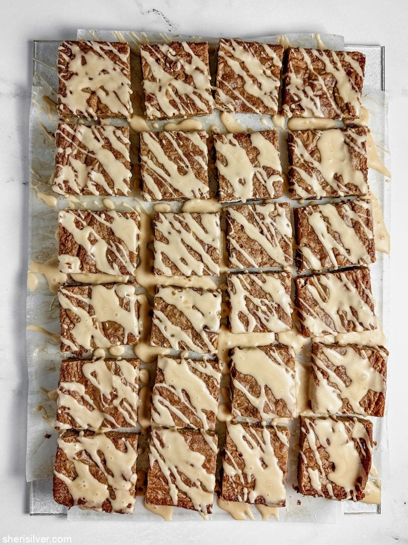mocha chip blondies with coffee glaze on parchment paper