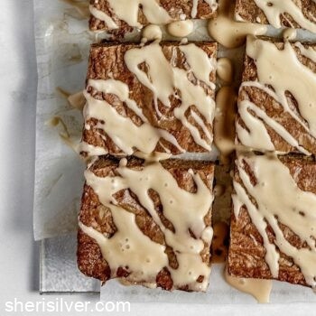 mocha chip blondies with coffee glaze on parchment paper