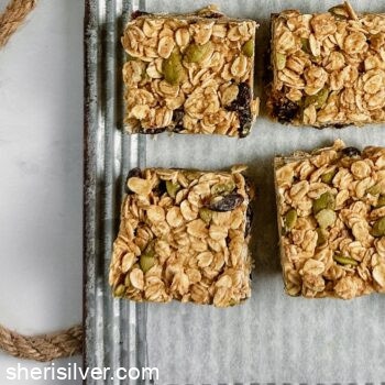 pumpkin spice granola bars on a parchment lined ribbed metal tray