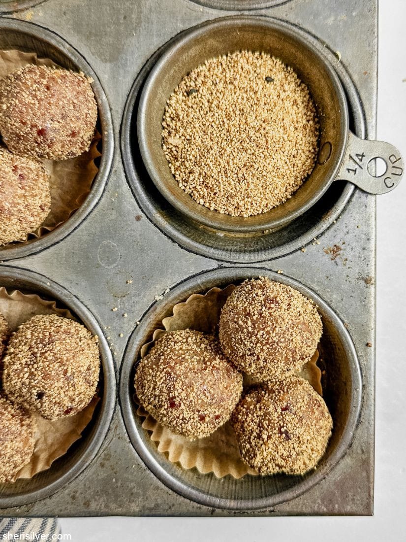 tahini date truffles in a vintage muffin tin with a dish of coffee cake sugar