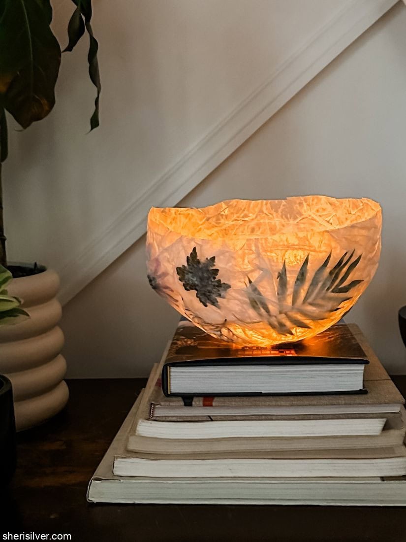 homemade nature lantern on a stack of books