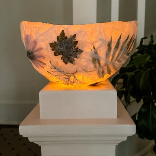 homemade nature lantern on a newel post