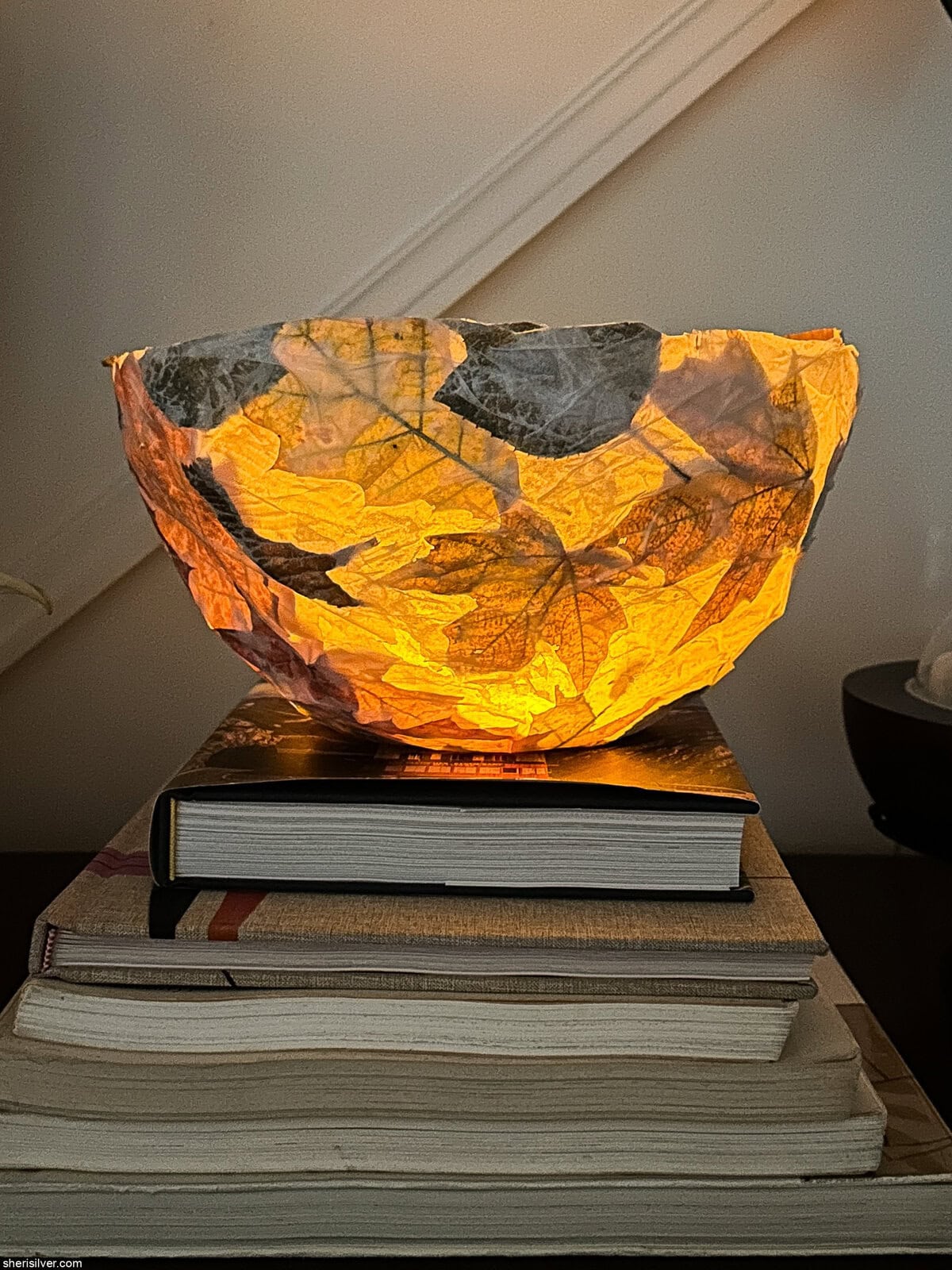 homemade nature lantern on a stack of books