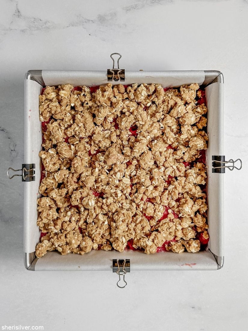 Raspberry oat squares in a square baking pan