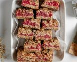 Raspberry oat squares in a parchment lined ceramic dish