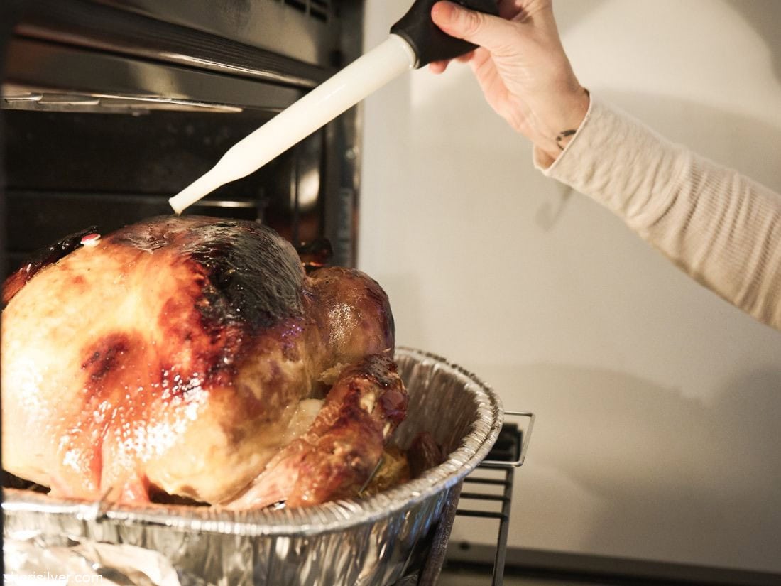 Thanksgiving turkey getting basted in the oven