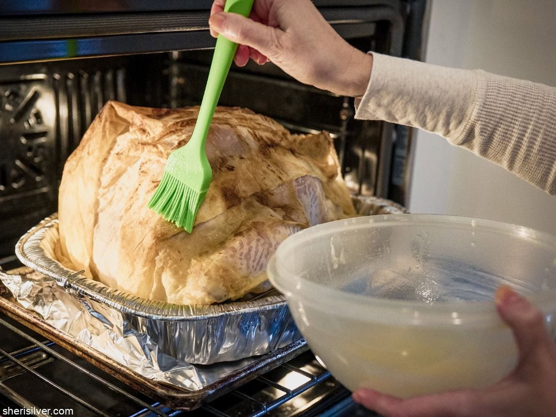 Thanksgiving turkey getting basted in the oven