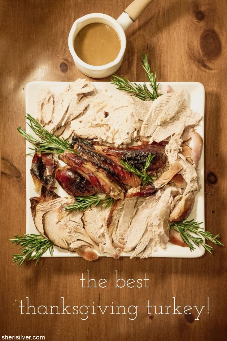 Thanksgiving turkey on a white platter with rosemary sprigs