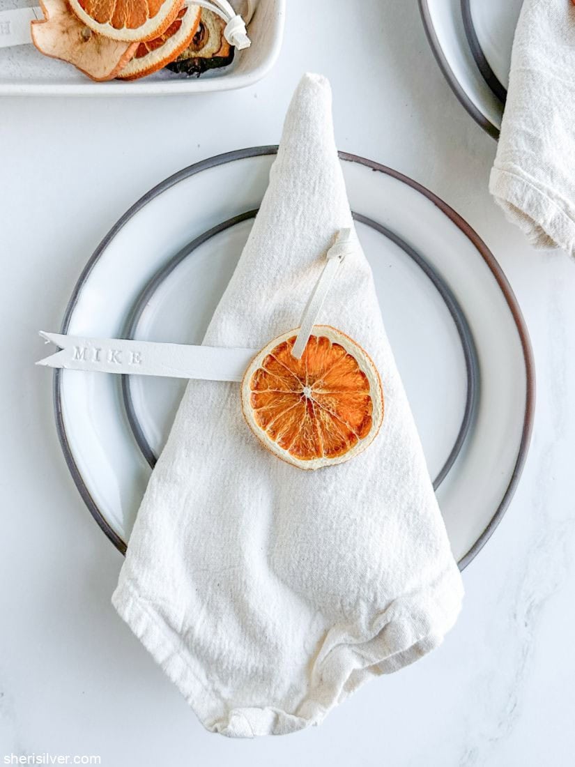 stamped clay place card on a linen napkin