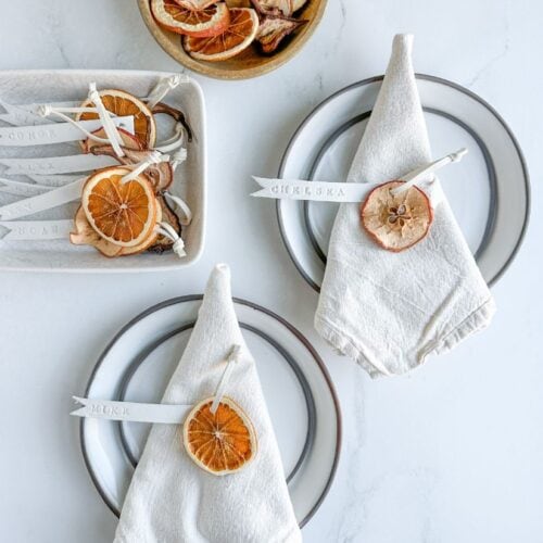 stamped clay place cards on linen napkins
