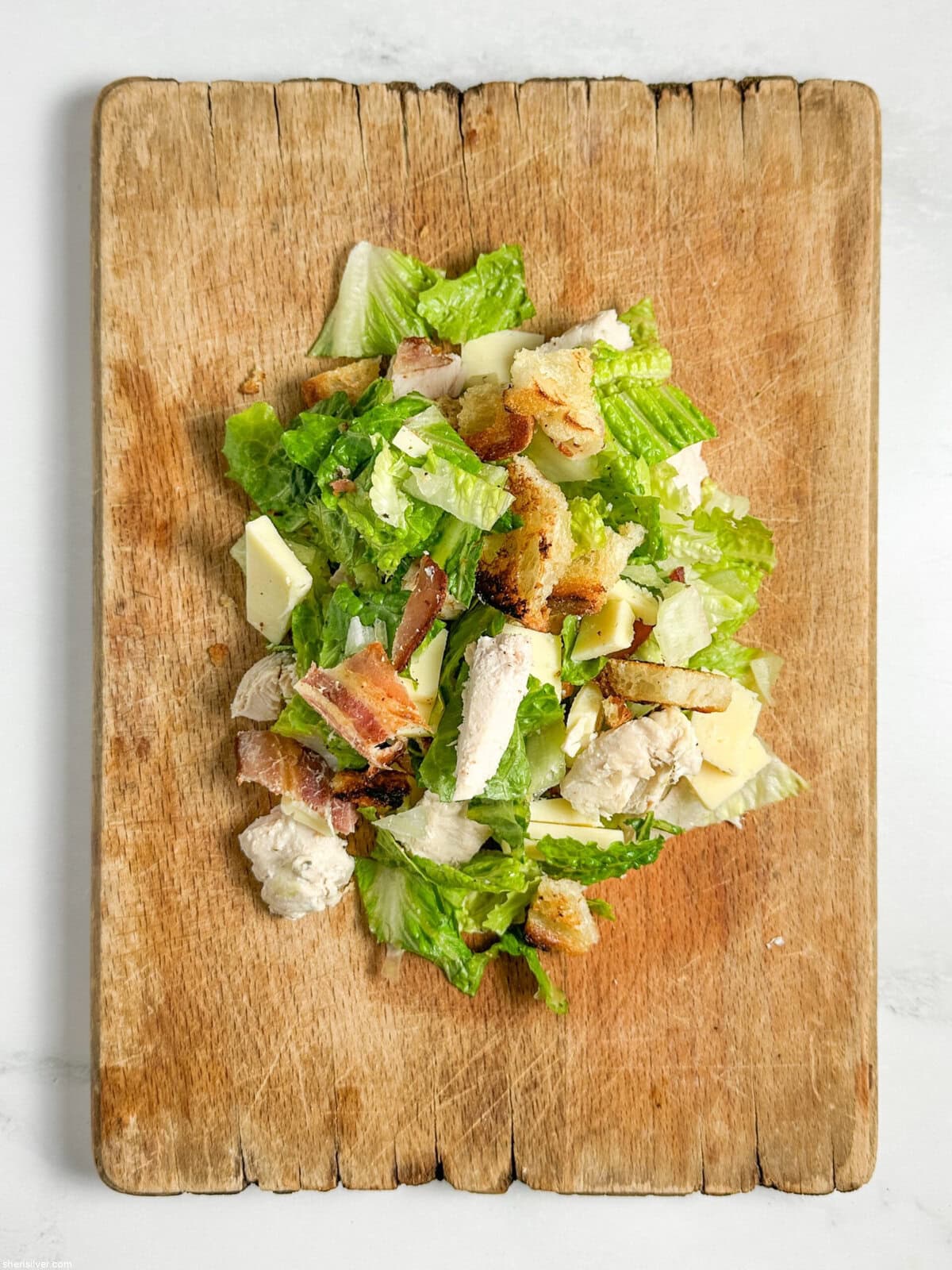 chicken club chopped salad on a cutting board
