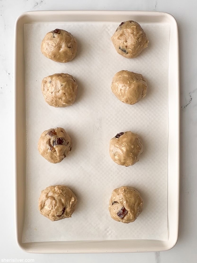 unbaked oatmeal date smash cookies on a baking sheet