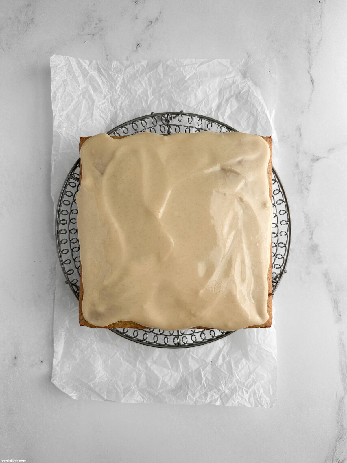 lemon ginger snacking cake with maple glaze on a cooling rack