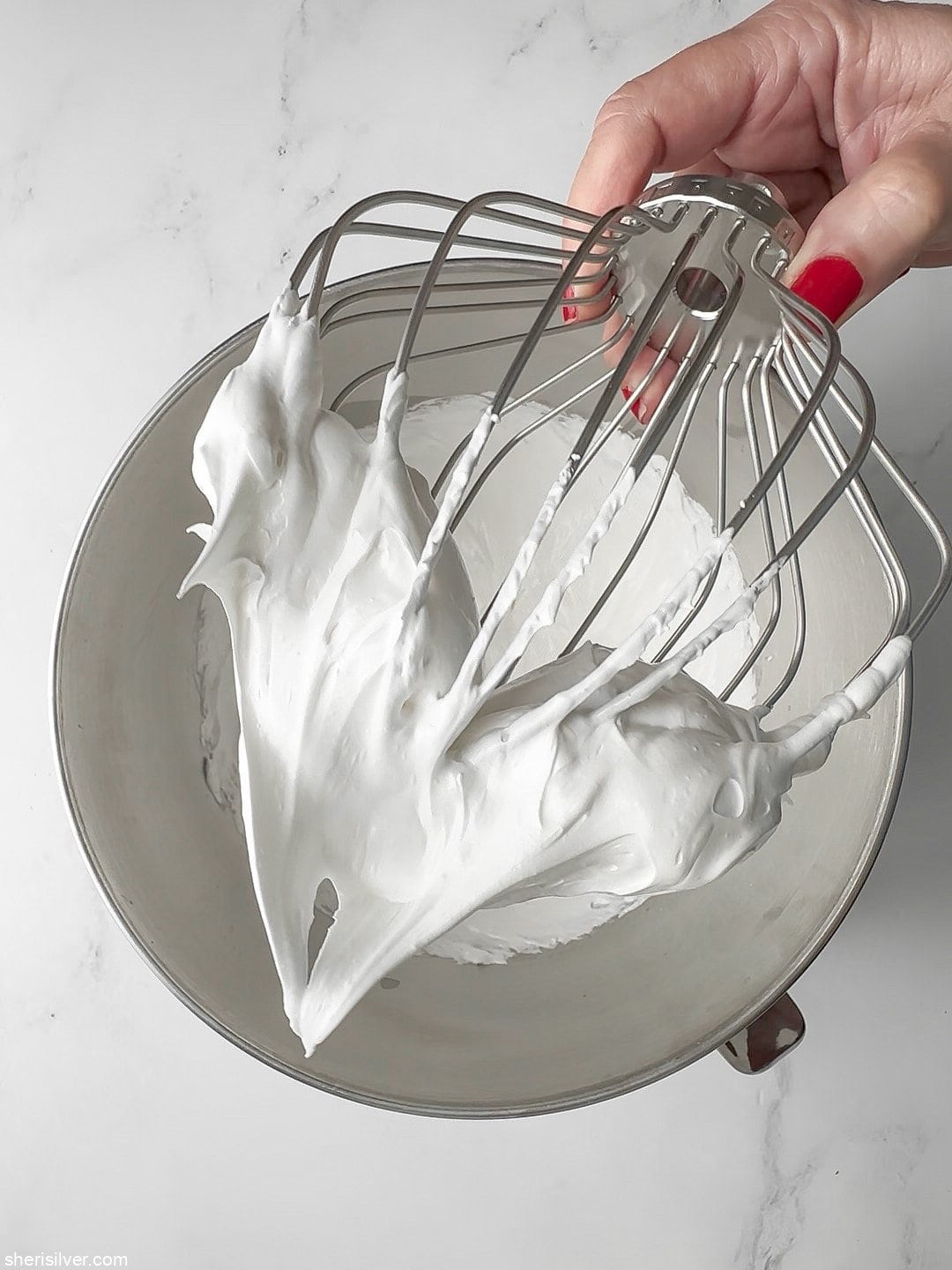 meringue on a beater whisk for red white and blue pavlova parfaits