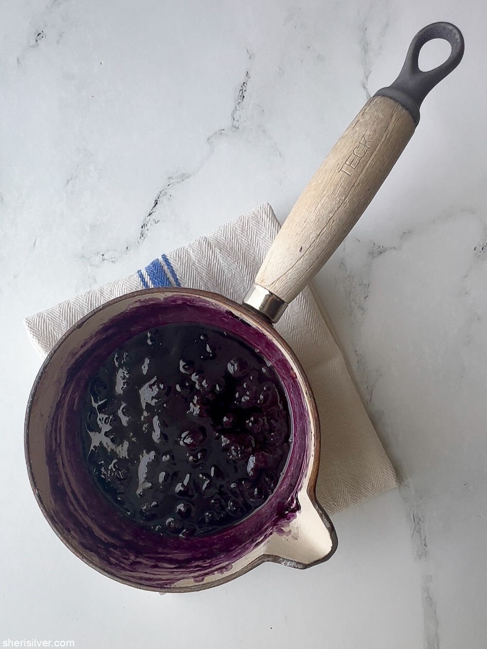 blueberry puree in a saucepan for red white and blue pavlova parfaits