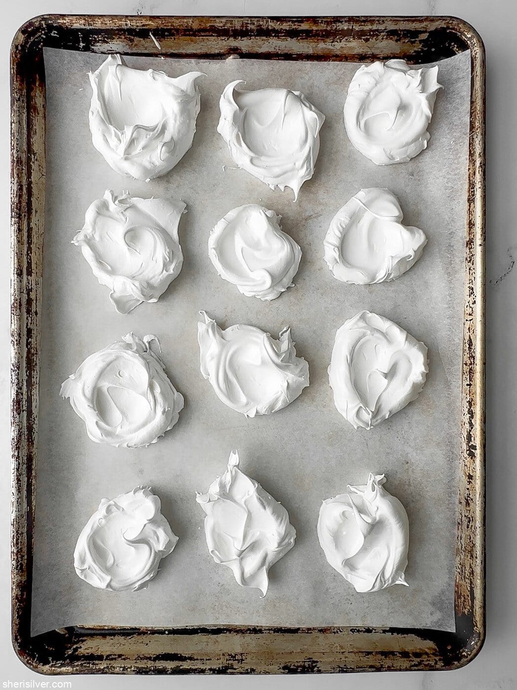 unbaked meringue on a baking sheet for red white and blue pavlova parfaits