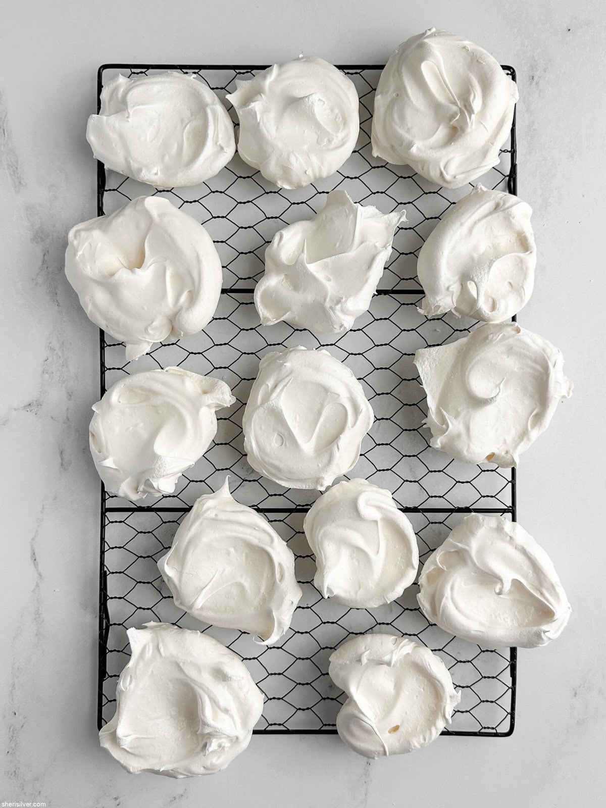 baked meringues for red white and blue pavlova parfaits on a wire rack