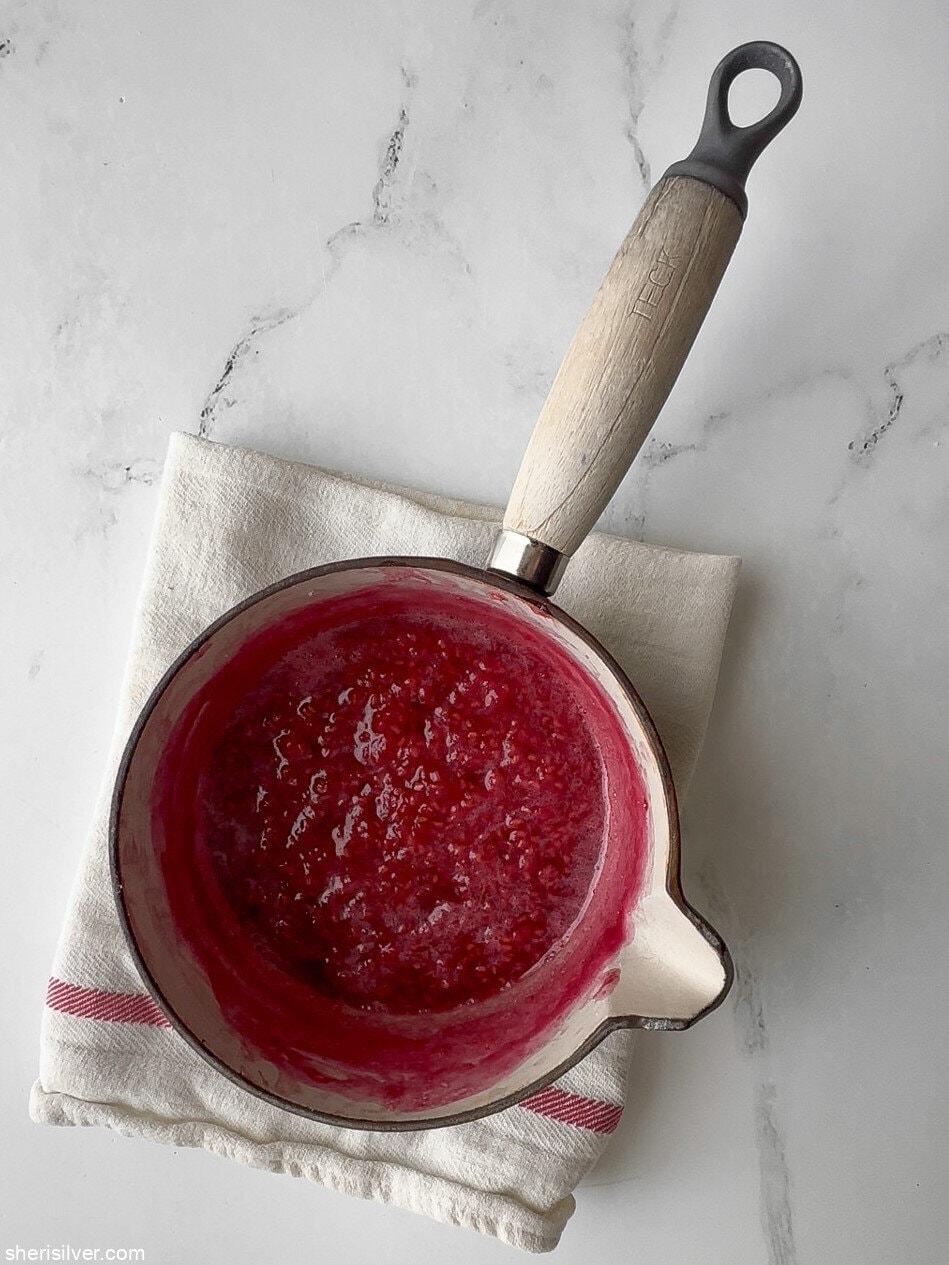 blueberry puree in a saucepan for red white and blue pavlova parfaits