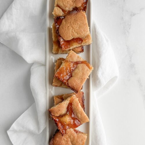 apricot almond bars on a white tray