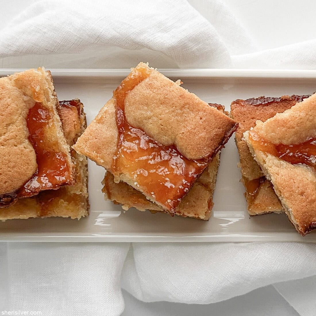 apricot almond bars on a white tray