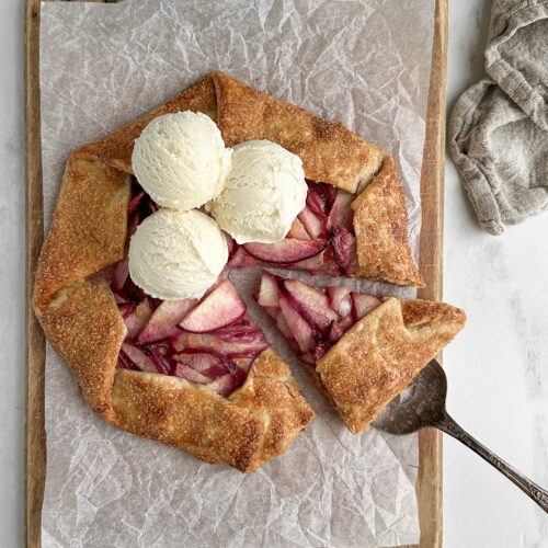 easy peach galette with vanilla ice cream on a wooden board