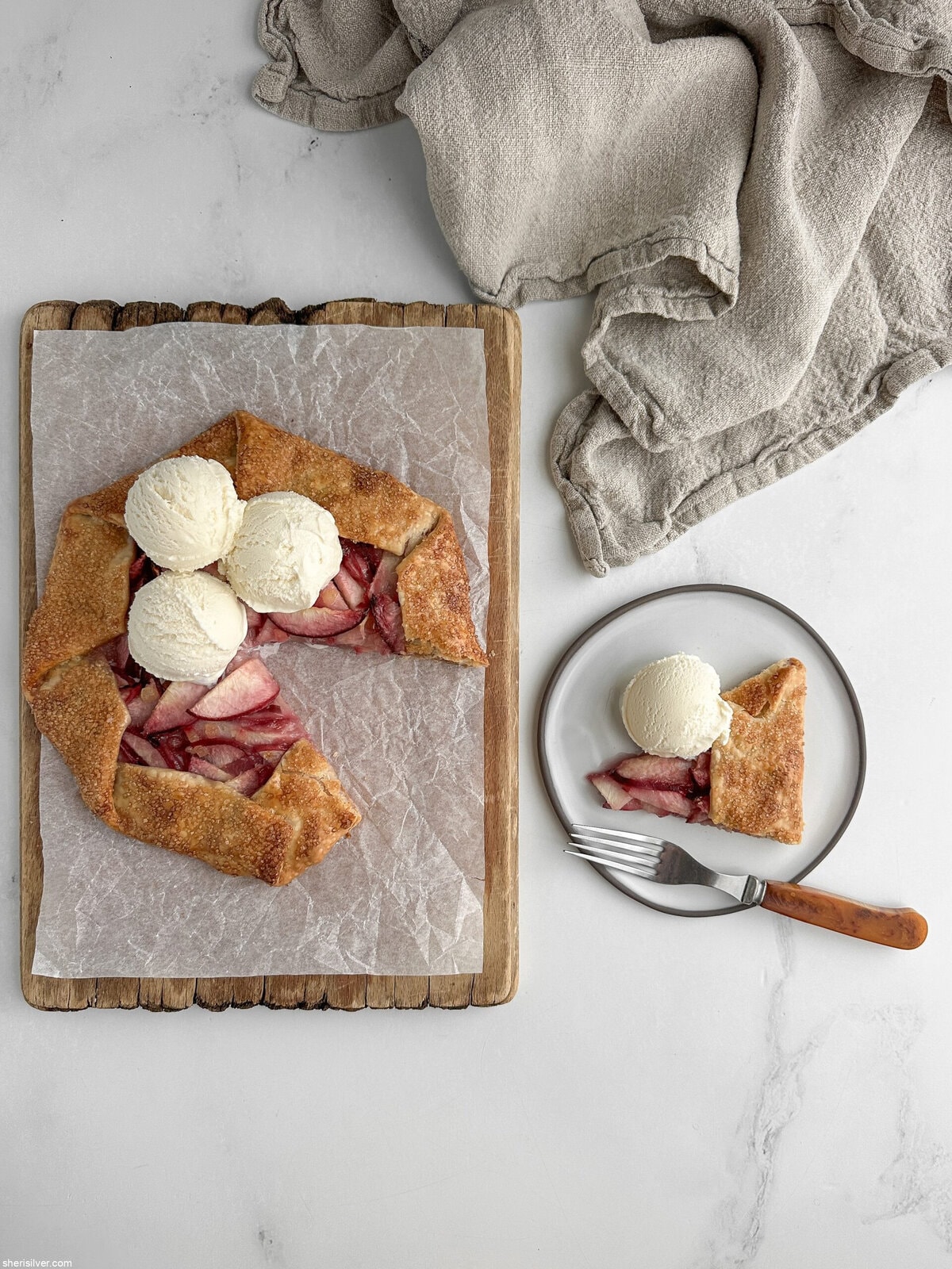 easy peach galette with vanilla ice cream on a wooden board