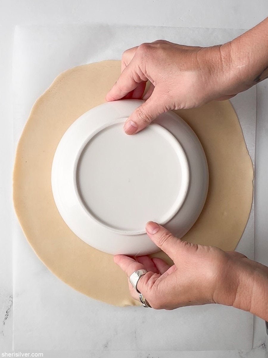 pie plate on pie dough for easy peach galette