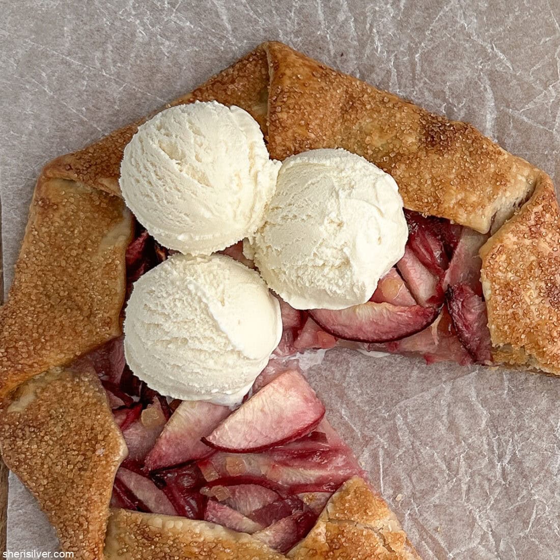 easy peach galette with vanilla ice cream on a wooden board
