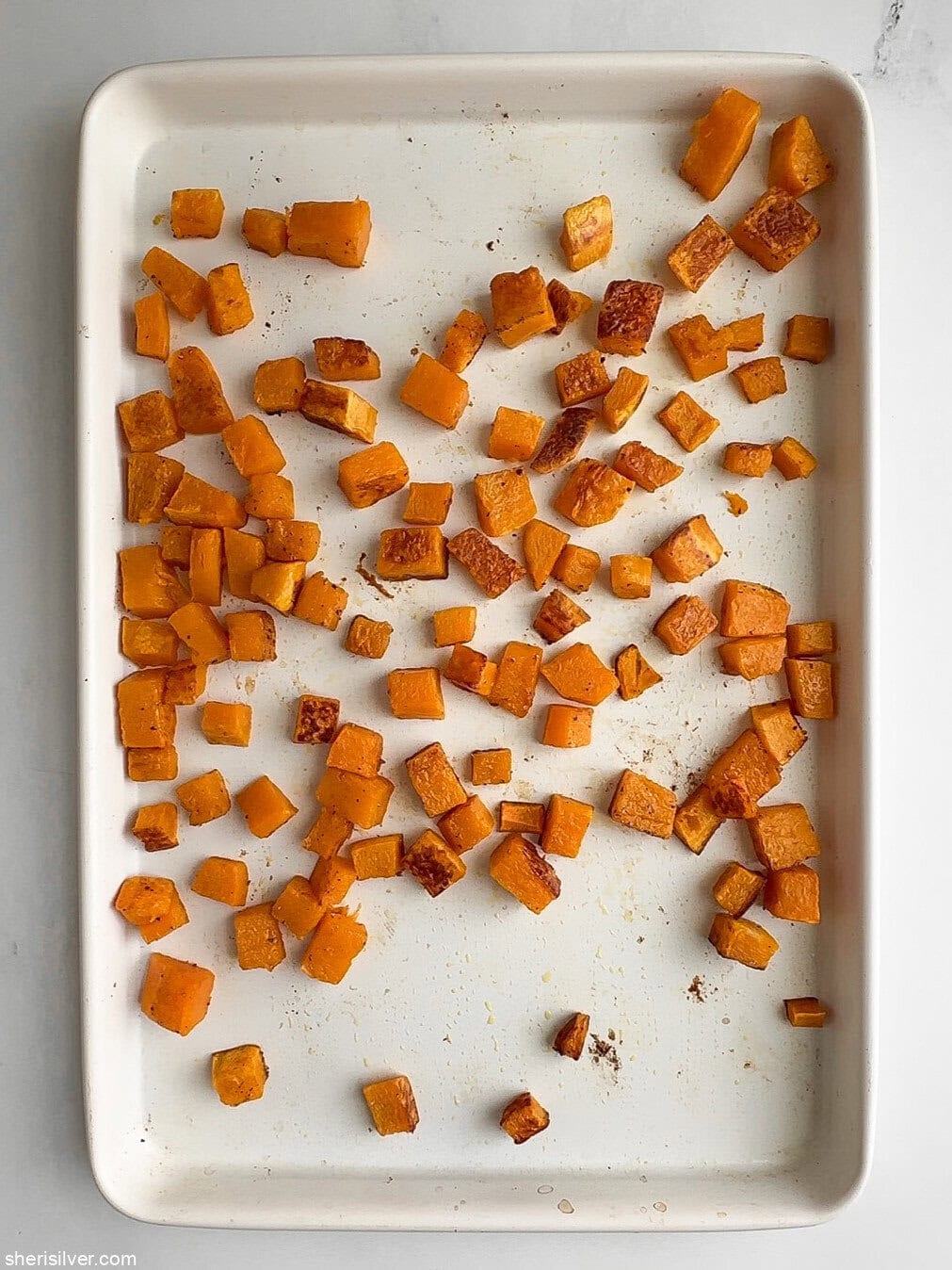 Roasted butternut squash cubes for arugula and date salad