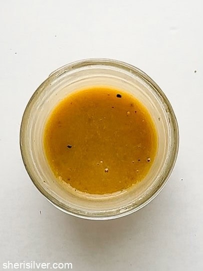 Homemade maple Dijon salad dressing mixed in a jar