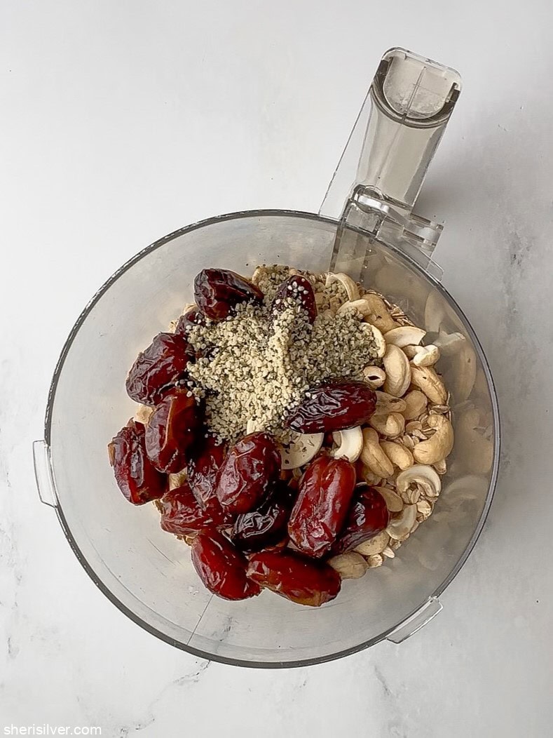ingredients for no bake tahini oat bars in a food processor