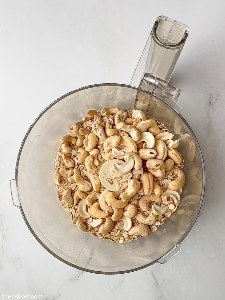 ingredients for no bake tahini oat bars in a food processor