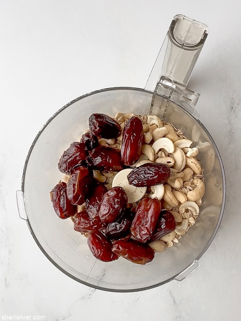 ingredients for no bake tahini oat bars in a food processor