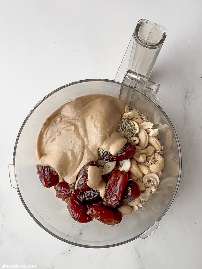ingredients for no bake tahini oat bars in a food processor