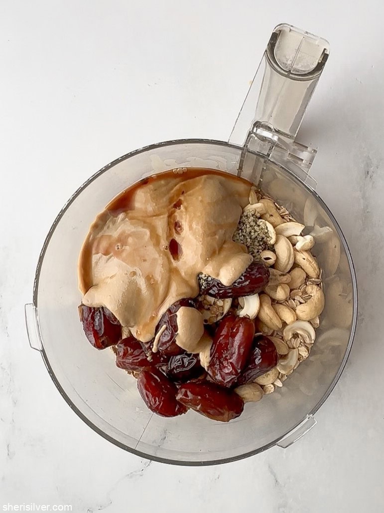 ingredients for no bake tahini oat bars in a food processor