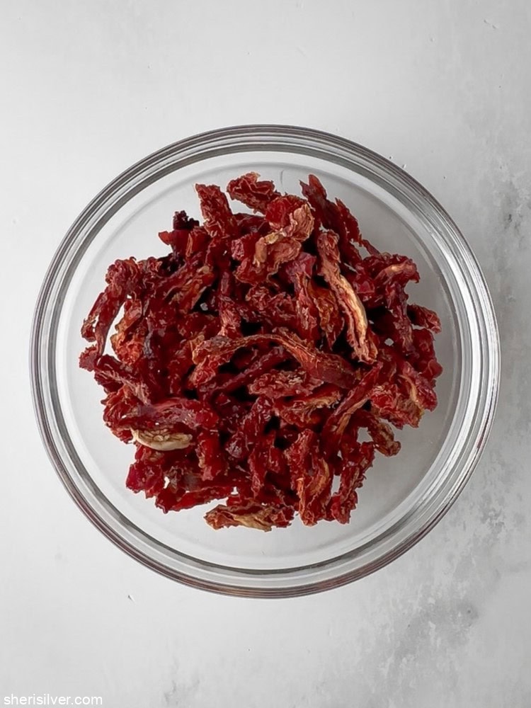 sundried tomatoes for Mediterranean tuna and white bean salad in a glass bowl