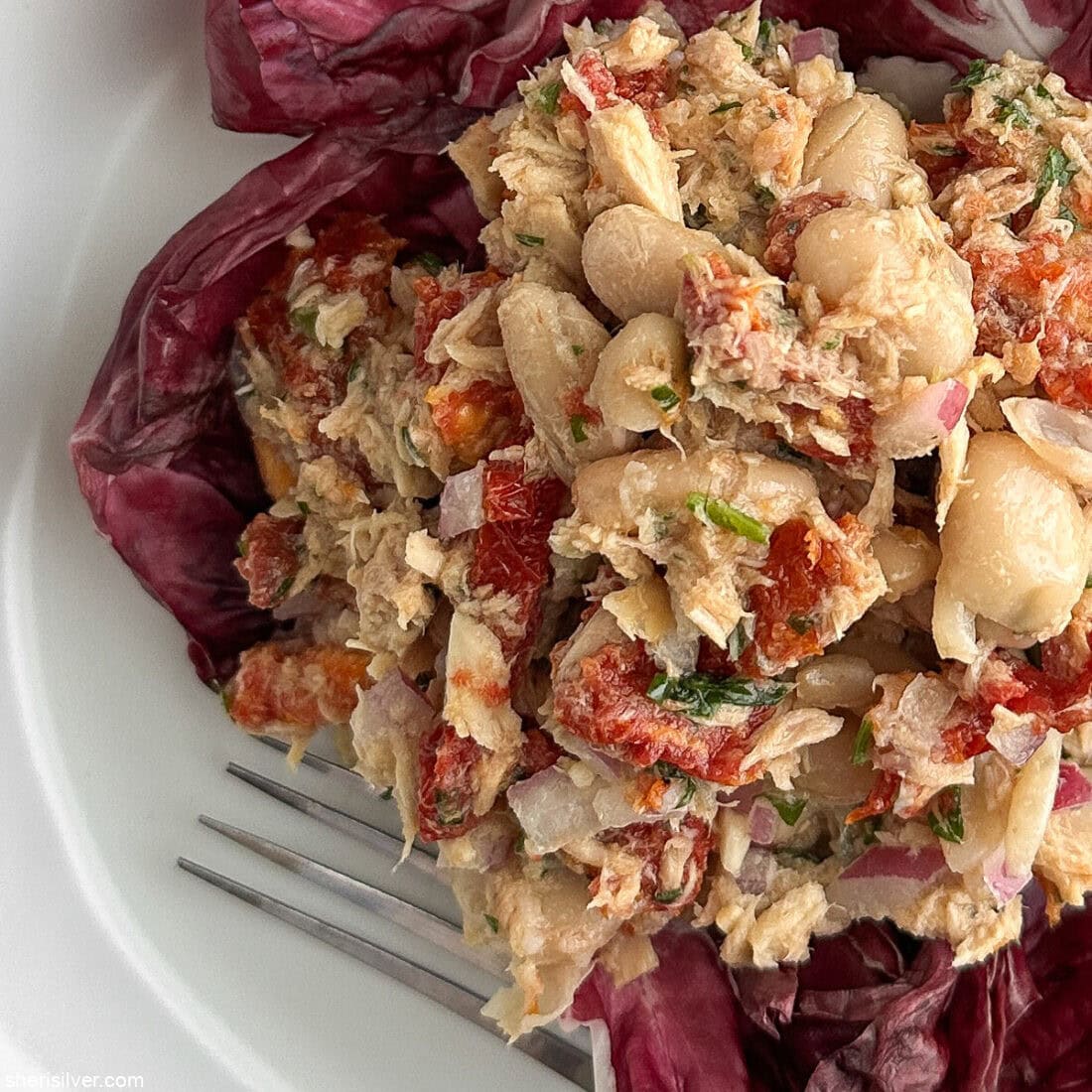 Mediterranean tuna and white bean salad on a ceramic plate