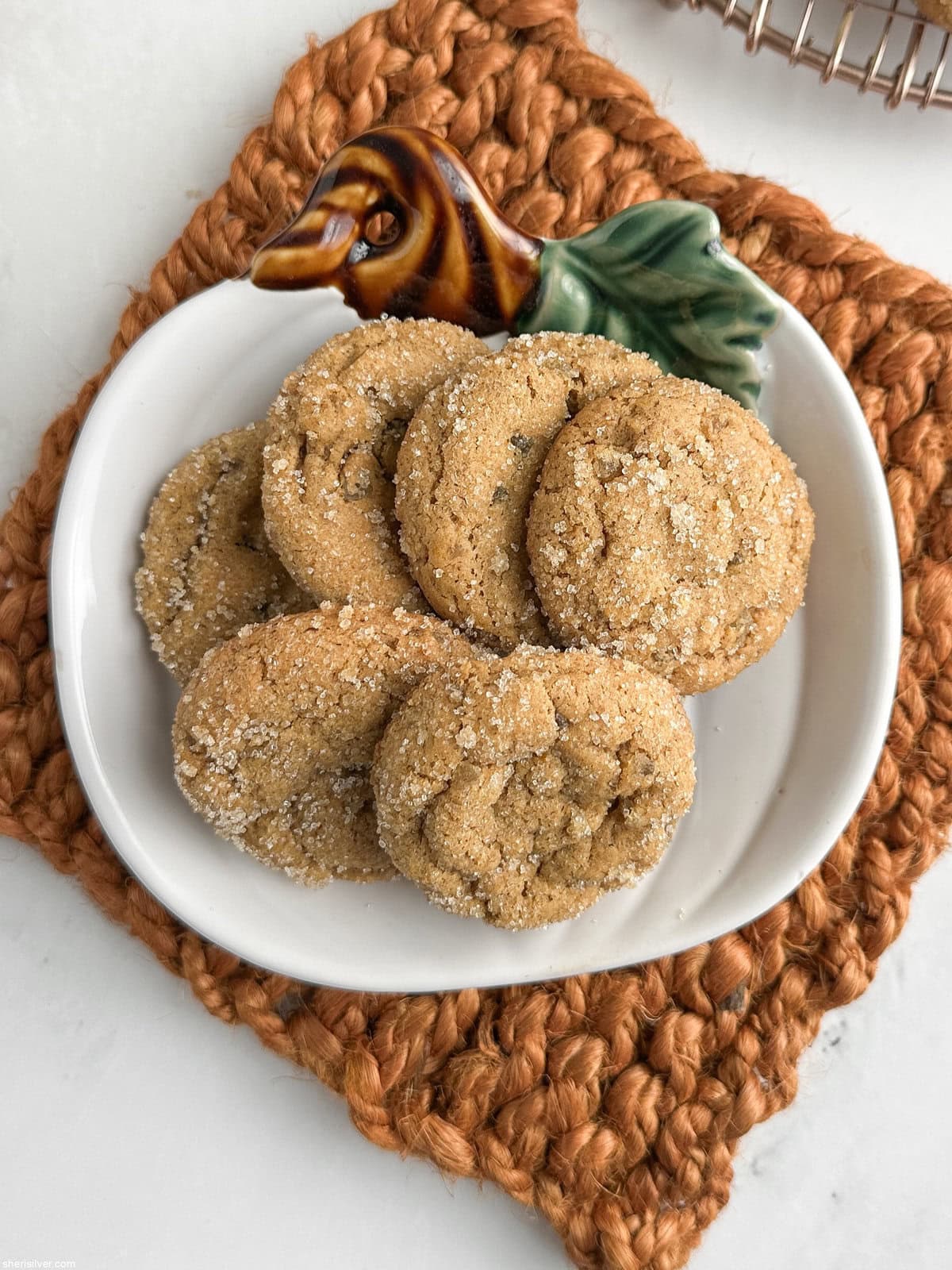 Chewy pumpkin cookies with candied ginger on a pumpkin-shaped plate with fall table decor