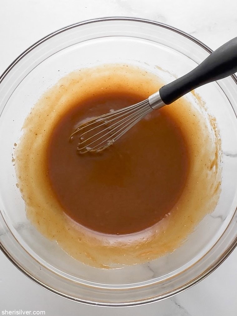 Pumpkin cookie wet ingredients whisked together in a glass bowl until smooth.