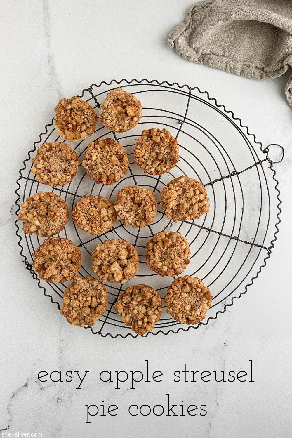 Apple streusel pie cookies displayed on a vintage wire cooling rack with a text title overlay.
