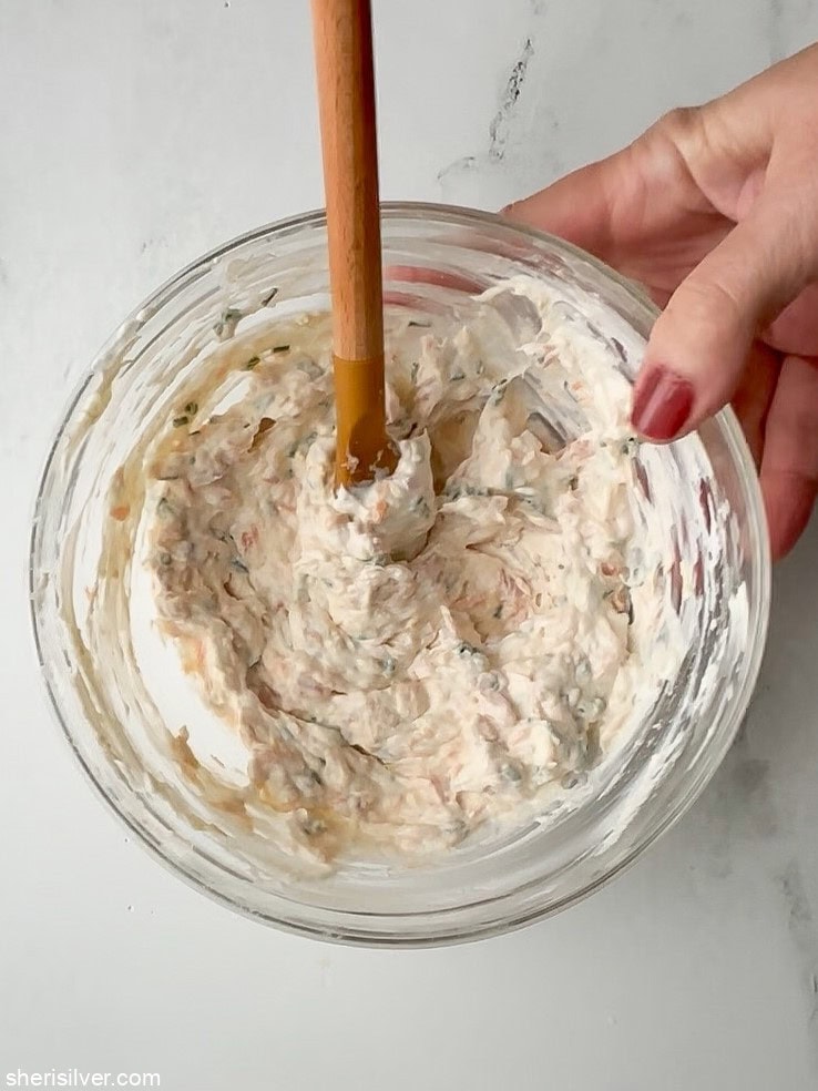 Close-up of smoked trout dip in a glass bowl.
