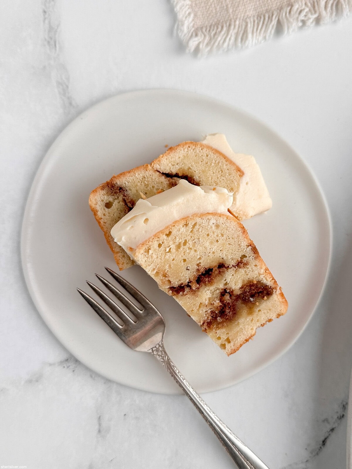 Close-up of a slice of cinnamon roll loaf cake showing cinnamon swirl layers.
