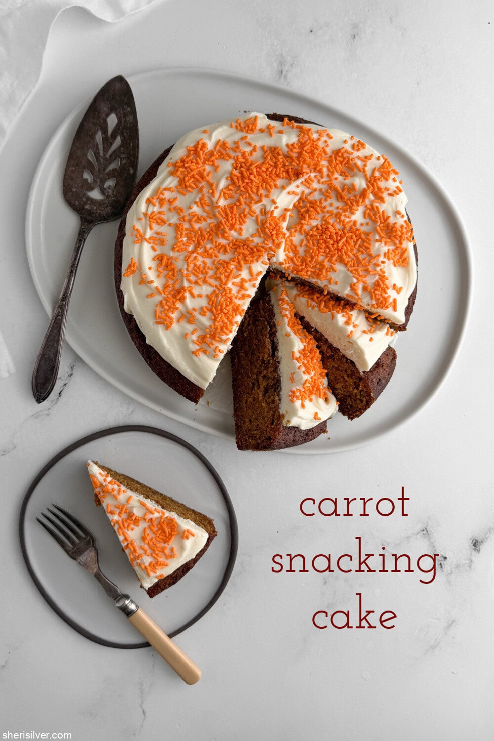 Frosted carrot snacking cake with cream cheese frosting and orange sprinkles on a platter with post title text overlay