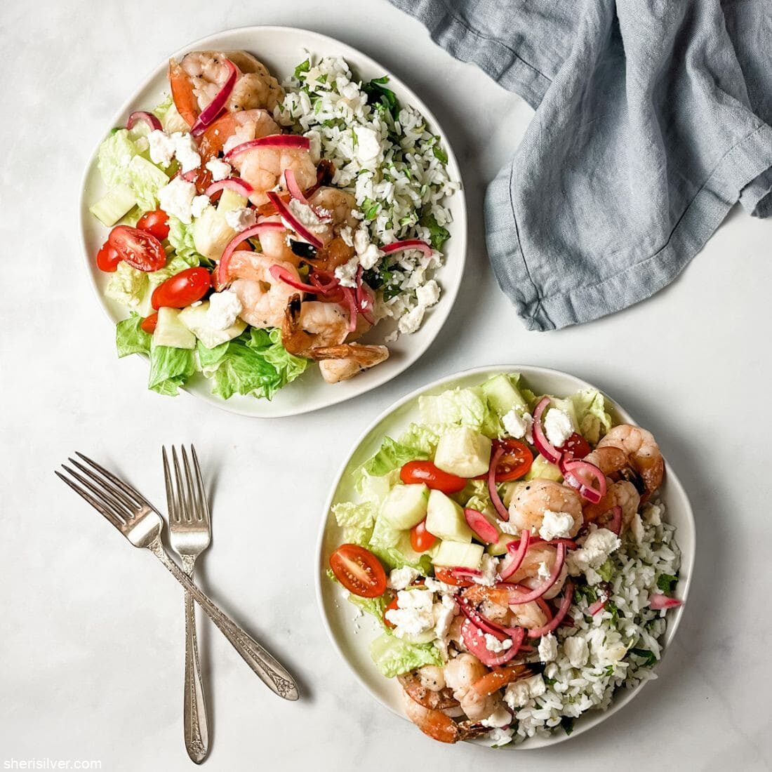 shrimp greek salad on serving plates